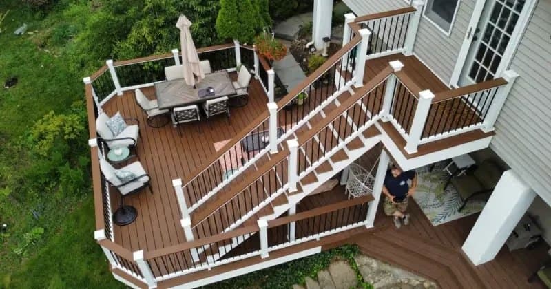Multi-level composite deck with pergola and outdoor lighting in a Pennsylvania backyard